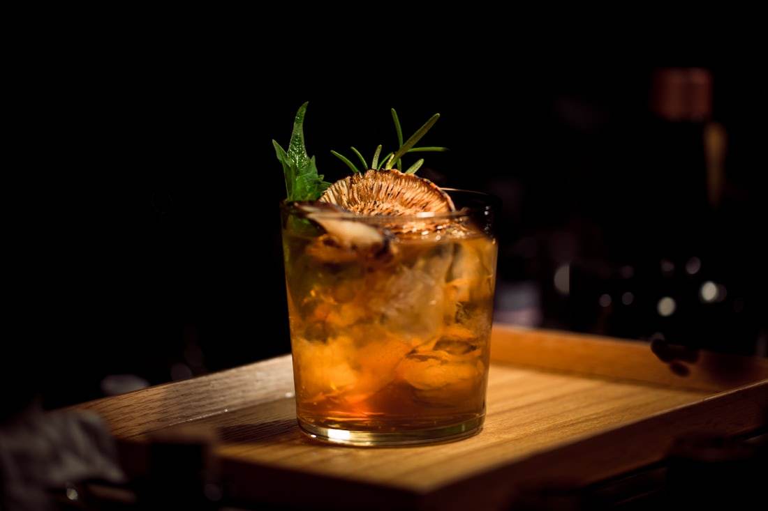 Old fashioned cocktail at a dark bar